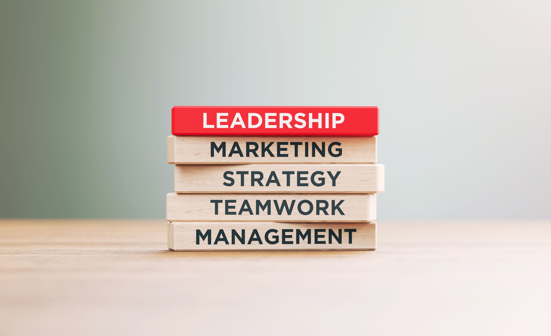 Leadership Related Words Written Wood Blocks Sitting on Wood Surface in Front a Defocused Background